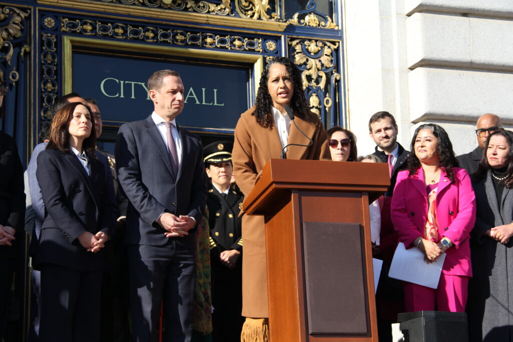 San Francisco District Attorney Brooke Jenkins stands at a podium speaking during a reproductive rights rally on the steps of San Francisco City Hall, surrounded by city officials and advocates, marking the 53rd anniversary of Roe v. Wade. Photo: Courtesy of the San Francisco Department on the Status of Women